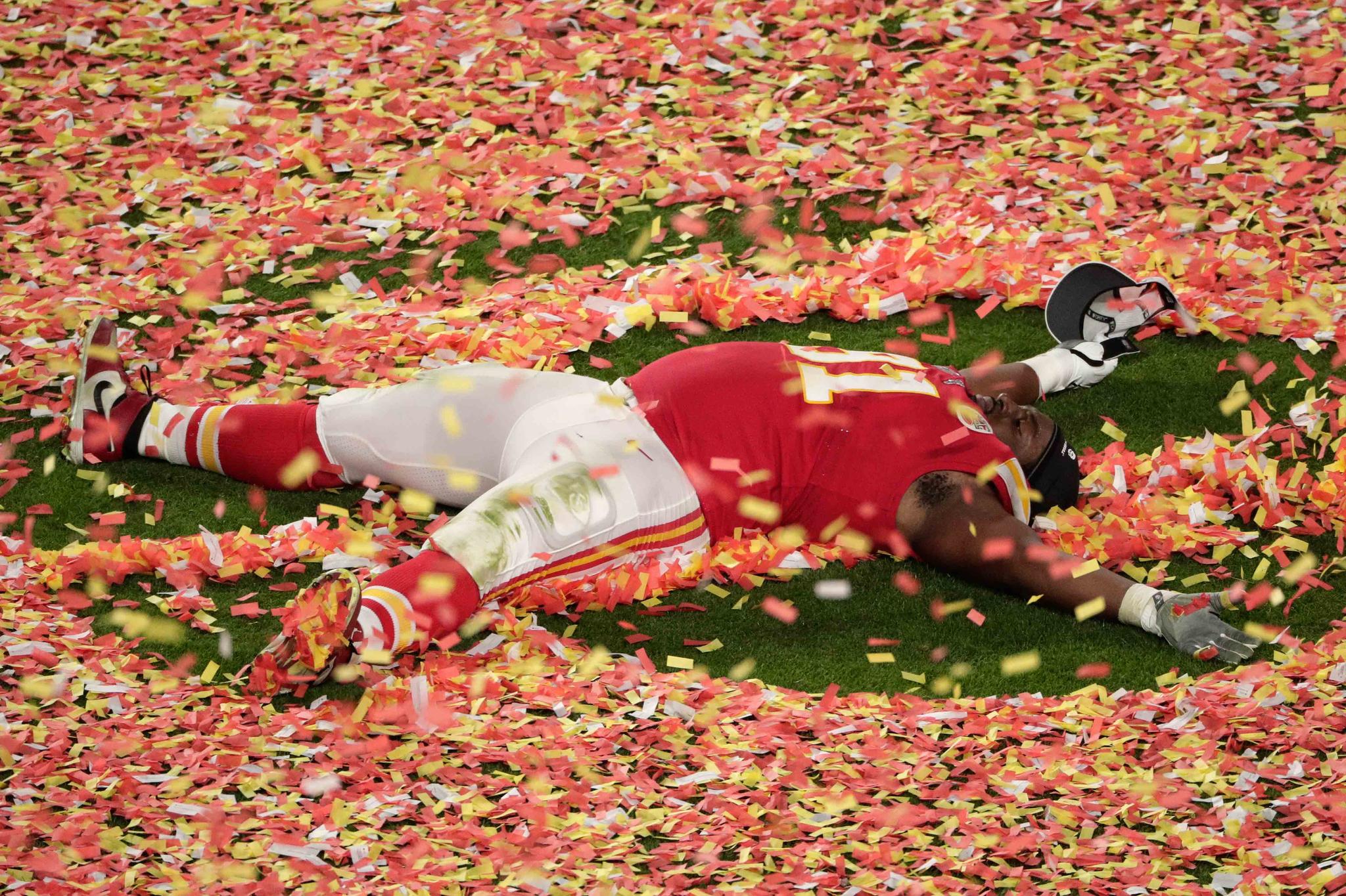 Kansas City Chiefs' Derrick Nnadi (91) plays with the confetti, at the end of the NFL Super Bowl 54 football game against the San Francisco 49ers