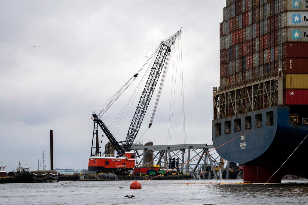 The Dali, right, a massive container ship from Singapore, still sits amid the wreckage and collapse of the Francis Scott Key Bridge in the Baltimore port
